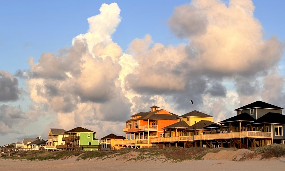 row of beach houses with a cloudy sky