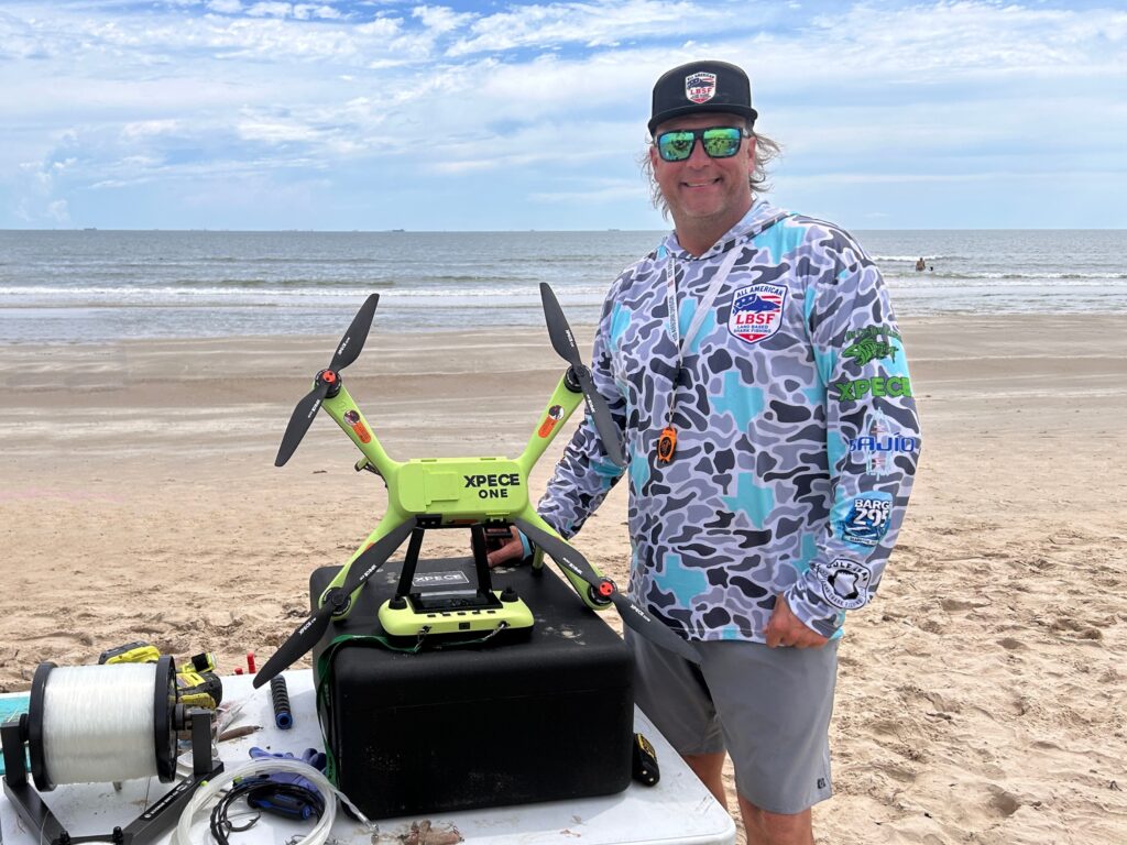 Fisherman with drone to carry bait offshore