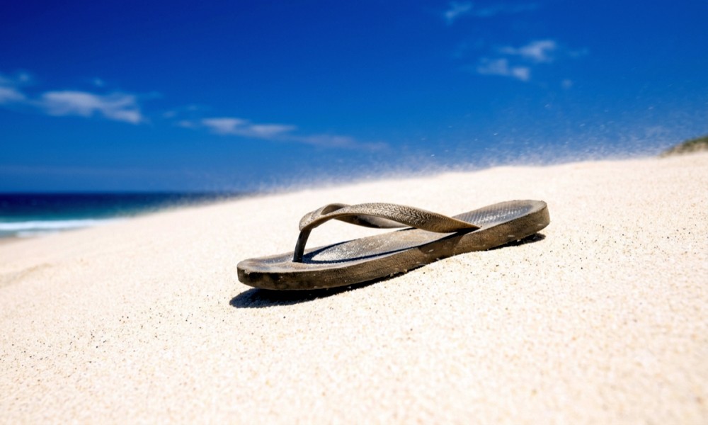 single flip-flop on the beach