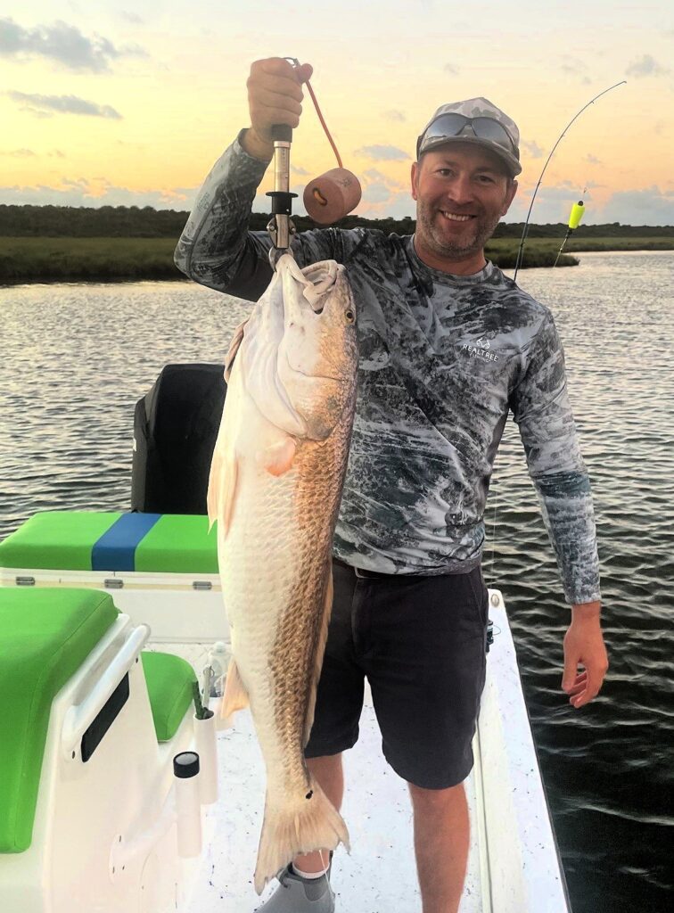 Fisherman holding a large bull redfish