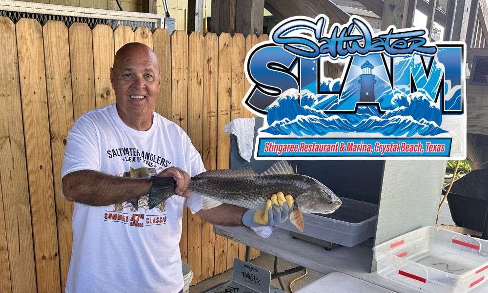 man holding a large redfish